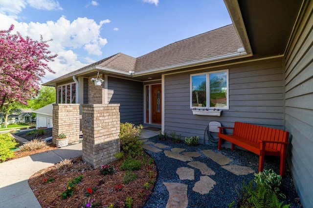 property entrance with roof with shingles