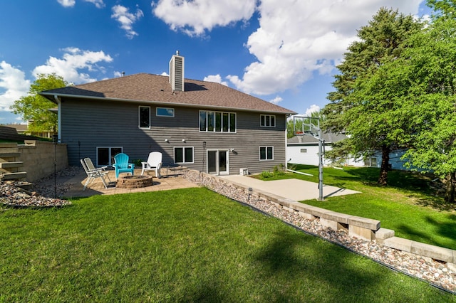 back of house with a patio, a chimney, an outdoor fire pit, and a lawn