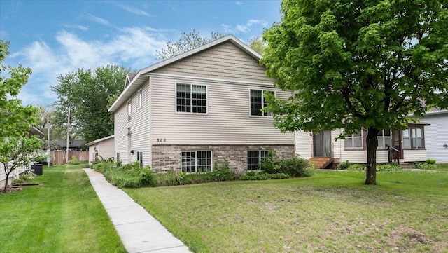 833 19th Ave N, Saint Cloud, MN 56303 - view of front of house with brick siding and central AC unit