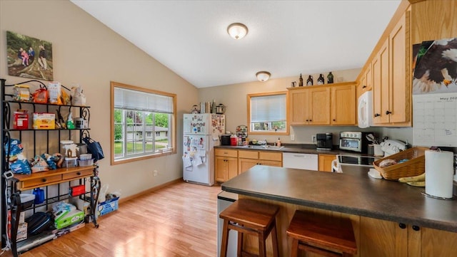 833 19th Ave N, Saint Cloud, MN 56303 - kitchen with white appliances, dark countertops, vaulted ceiling, a peninsula, and a sink