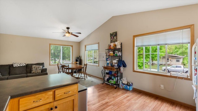 833 19th Ave N, Saint Cloud, MN 56303 - kitchen featuring light wood-style floors, ceiling fan, baseboards, lofted ceiling, and dark countertops