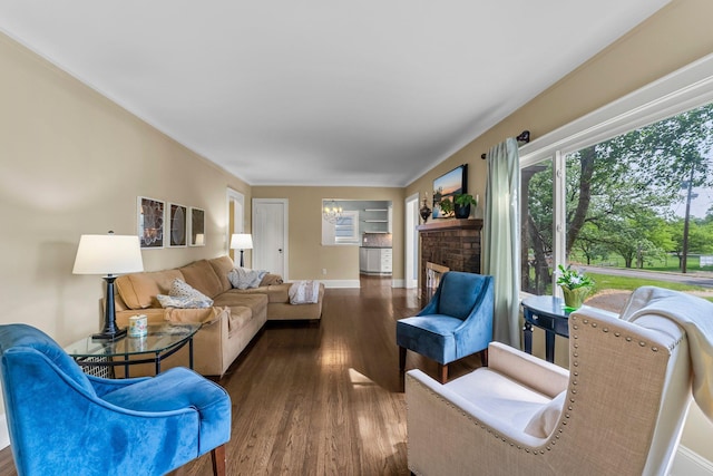 living room with wood finished floors, baseboards, and a chandelier
