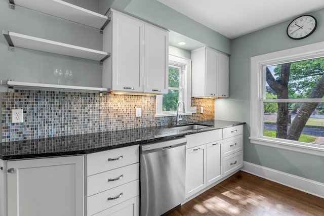 kitchen with dishwasher, open shelves, a sink, dark stone countertops, and white cabinets