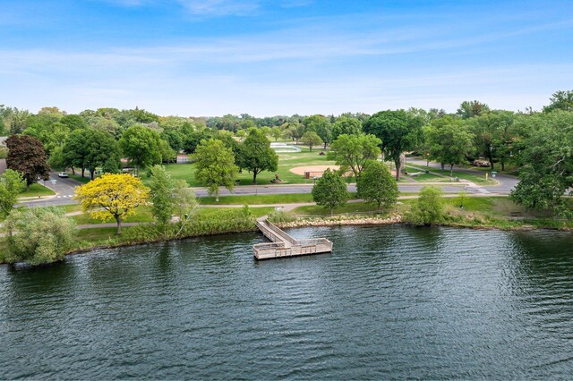 water view with a floating dock and a tree filled landscape
