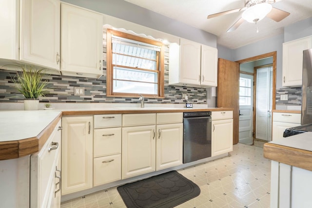 kitchen with dishwasher, a sink, healthy amount of natural light, and decorative backsplash