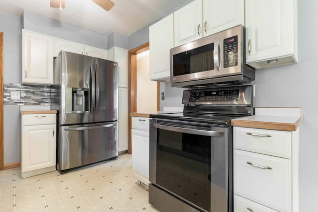 kitchen with appliances with stainless steel finishes, white cabinets, and light countertops