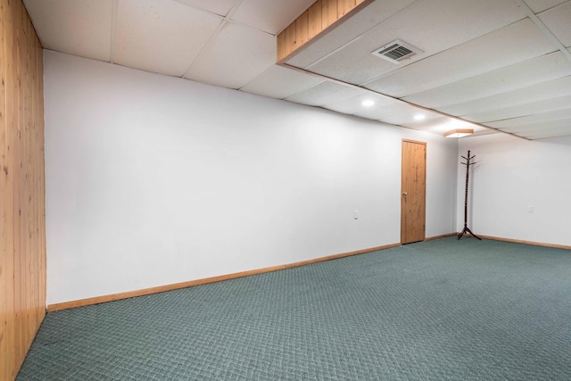 empty room featuring carpet flooring, a drop ceiling, baseboards, and recessed lighting