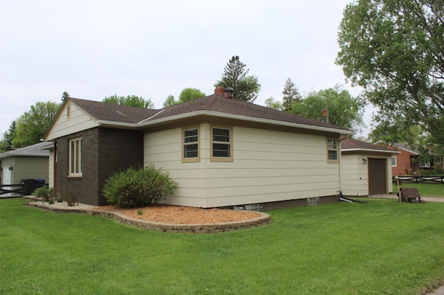 view of home's exterior with a yard and a garage