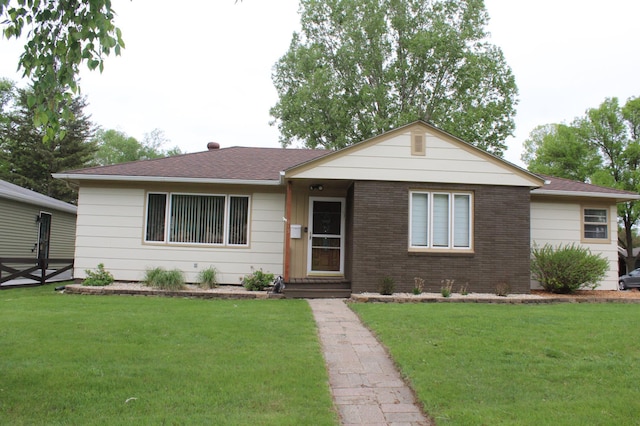 single story home with a front yard and brick siding