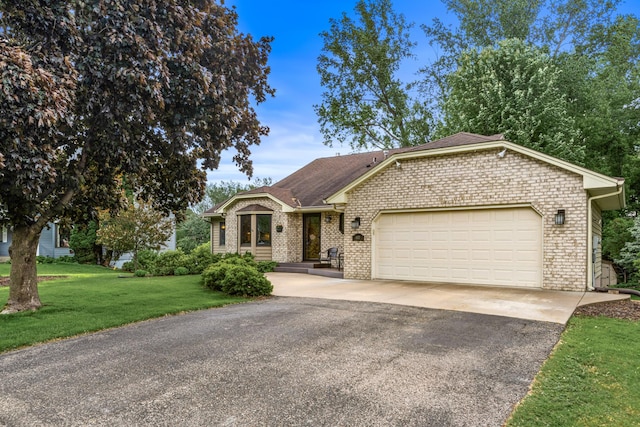 480 Suzanne Ave, Shoreview, MN 55126 - view of front of house featuring asphalt driveway, a garage, brick siding, a front yard, and a shingled roof