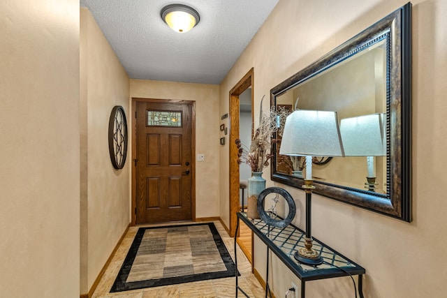 480 Suzanne Ave, Shoreview, MN 55126 - entryway featuring inlaid floor details, baseboards, and a textured ceiling