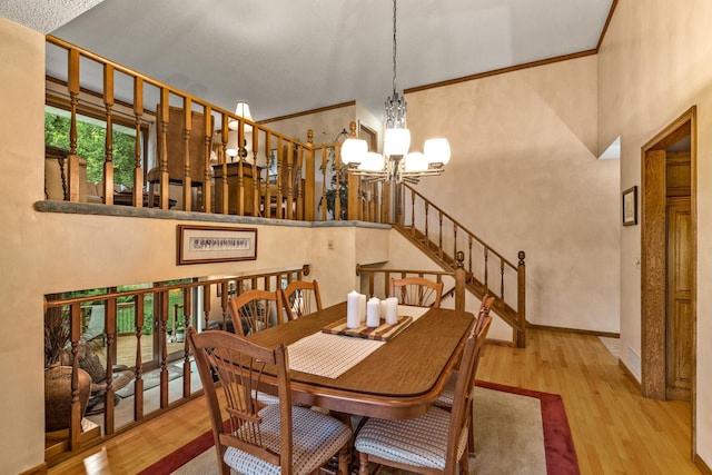 480 Suzanne Ave, Shoreview, MN 55126 - dining room featuring a chandelier, wood finished floors, a high ceiling, stairs, and baseboards