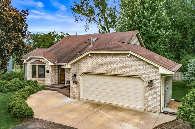 480 Suzanne Ave, Shoreview, MN 55126 - view of front of house with brick siding, concrete driveway, a garage, and roof with shingles
