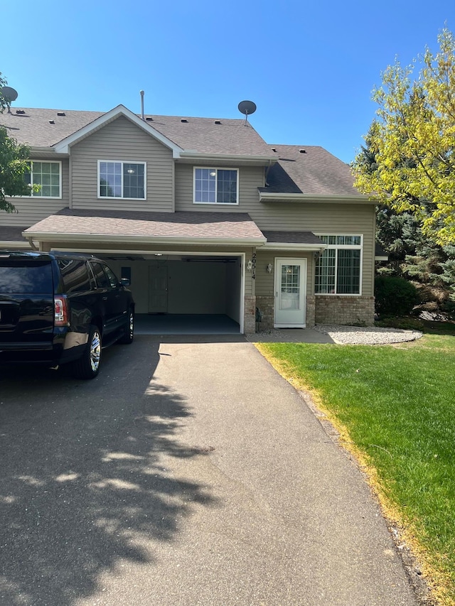 20514 Erin Ct Unit 15, Farmington, MN 55024 - view of front of home with driveway, a garage, brick siding, a front lawn, and a shingled roof