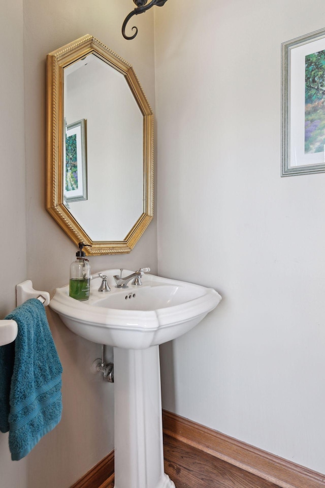 1438 Kings Wood Rd, Eagan, MN 55122 - bathroom with a sink, baseboards, and wood finished floors