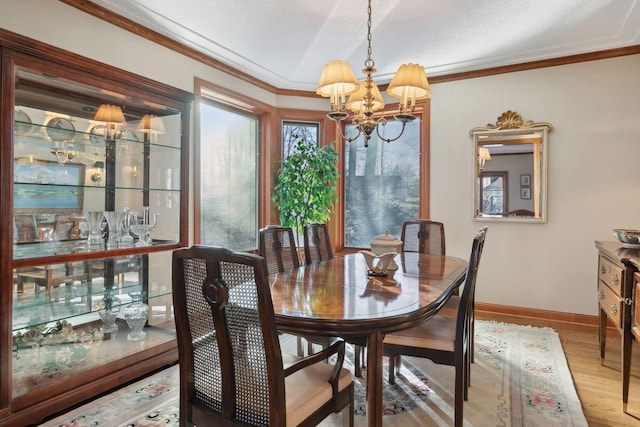 1438 Kings Wood Rd, Eagan, MN 55122 - dining area featuring a chandelier, wood finished floors, baseboards, and ornamental molding