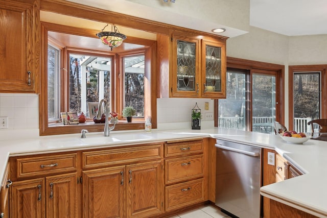 1438 Kings Wood Rd, Eagan, MN 55122 - kitchen featuring stainless steel dishwasher, a sink, and brown cabinetry