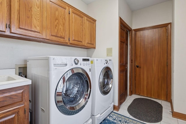 1438 Kings Wood Rd, Eagan, MN 55122 - clothes washing area featuring cabinet space, separate washer and dryer, light tile patterned floors, and baseboards