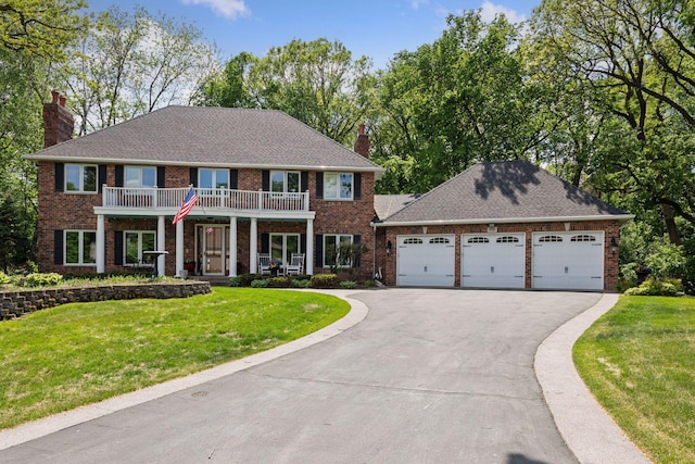 1438 Kings Wood Rd, Eagan, MN 55122 - colonial-style house with a chimney, driveway, an attached garage, and a front yard