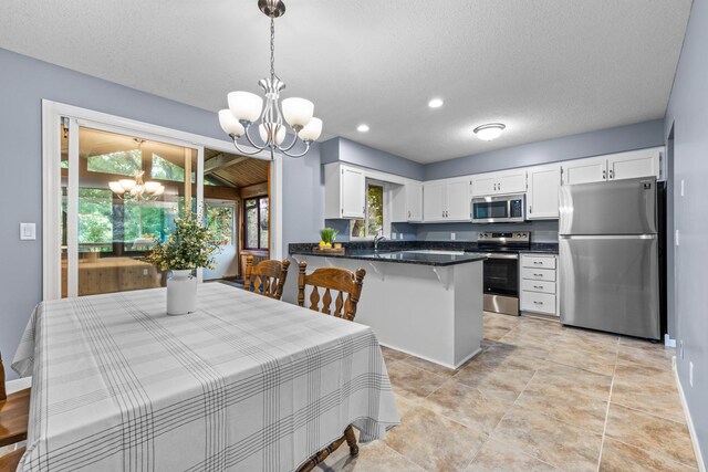 824 96th Ln NE, Blaine, MN 55434 - dining space featuring a chandelier, a textured ceiling, and recessed lighting