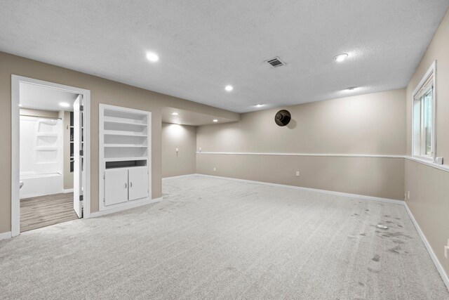 824 96th Ln NE, Blaine, MN 55434 - below grade area featuring carpet, recessed lighting, built in shelves, and a textured ceiling