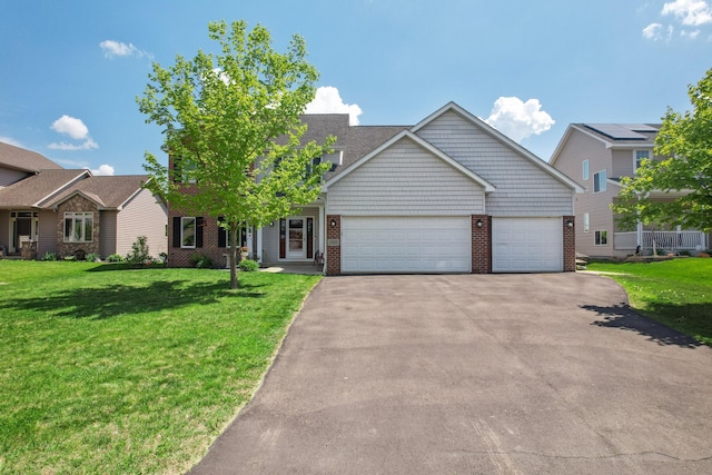 1005 Hope Ave, Jordan, MN 55352 - view of front of property with driveway, an attached garage, a front lawn, and brick siding