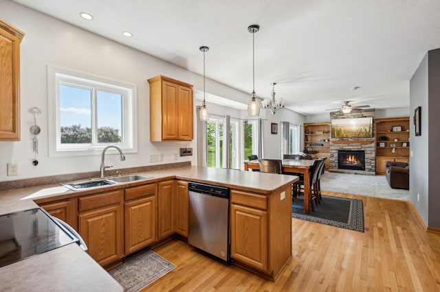 1005 Hope Ave, Jordan, MN 55352 - kitchen with stainless steel dishwasher, a sink, a peninsula, a ceiling fan, and light wood-type flooring