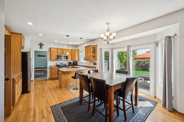 1005 Hope Ave, Jordan, MN 55352 - dining space featuring light wood-style floors, a chandelier, and recessed lighting