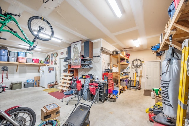 1005 Hope Ave, Jordan, MN 55352 - garage featuring freestanding refrigerator and a workshop area
