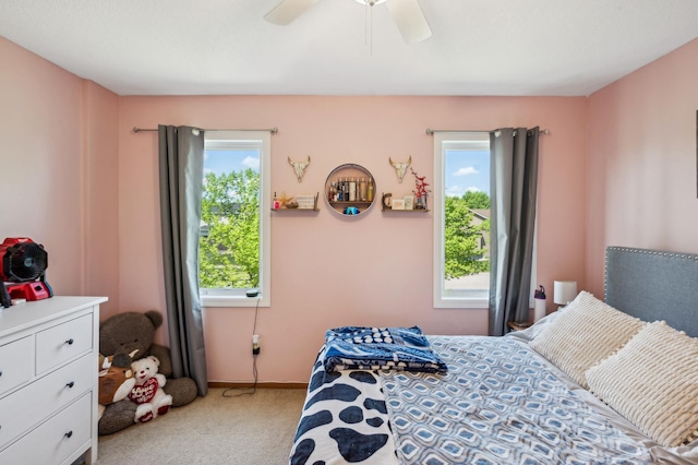 1005 Hope Ave, Jordan, MN 55352 - bedroom featuring multiple windows, carpet floors, ceiling fan, and baseboards