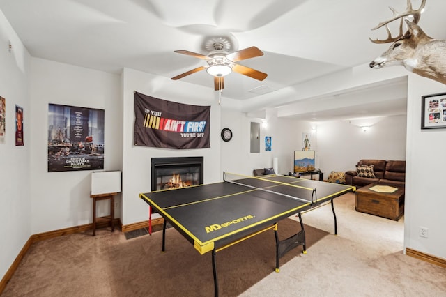 1005 Hope Ave, Jordan, MN 55352 - game room featuring carpet floors, baseboards, a glass covered fireplace, and a ceiling fan