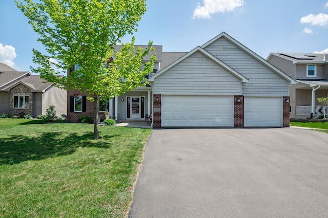 1005 Hope Ave, Jordan, MN 55352 - view of front of property with a garage, driveway, brick siding, and a front lawn
