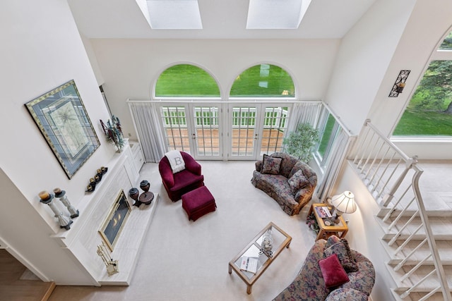 3140 Burr Oak Cir, Chaska, MN 55318 - living area featuring a skylight, stairs, a high ceiling, and french doors