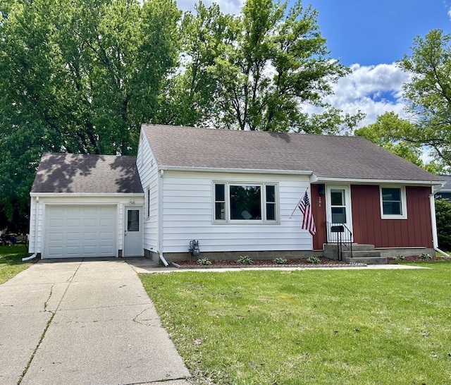 204 10th Ave NE, Waseca, MN 56093 - view of front facade with an attached garage, a front lawn, concrete driveway, and roof with shingles