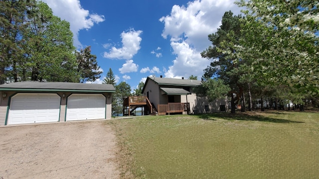 view of front of property with a deck, a front yard, a garage, and stairs