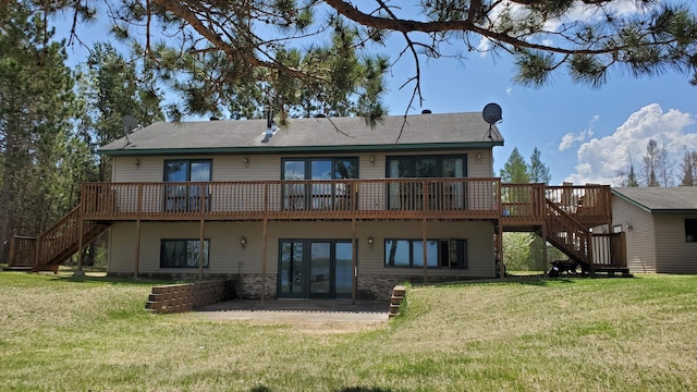 rear view of house featuring stairway, a wooden deck, french doors, and a yard
