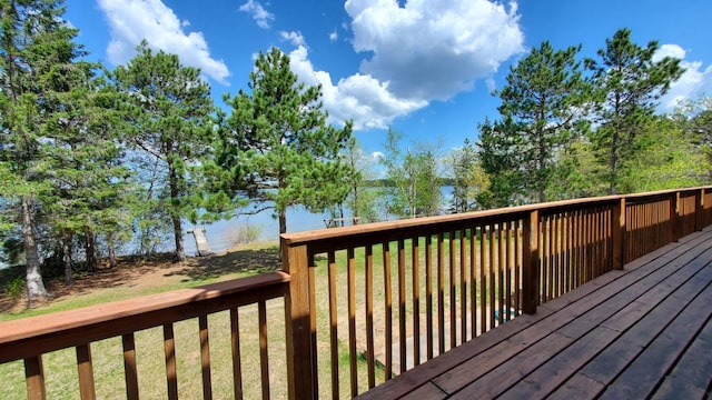 wooden terrace with a lawn