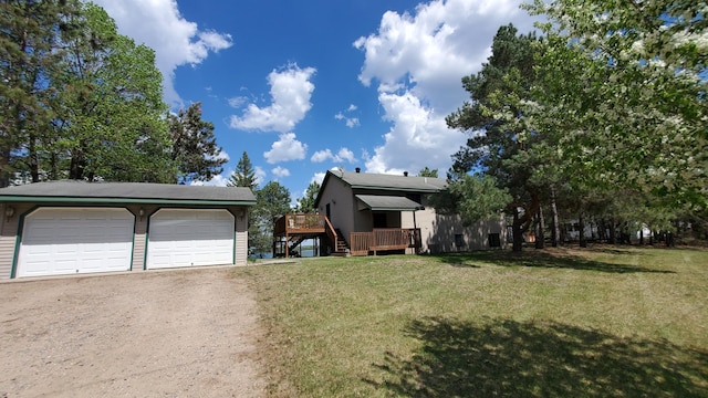 view of front facade featuring a wooden deck, a front lawn, a garage, and stairs