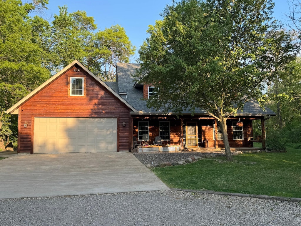 4060 Bunker Lake Blvd NE, Ham Lake, MN 55304 - view of front of home with a porch, concrete driveway, a front lawn, and roof with shingles