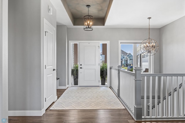 1991 69th Ave S, Fargo, ND 58104 - foyer entrance featuring a chandelier, baseboards, dark wood finished floors, and a raised ceiling
