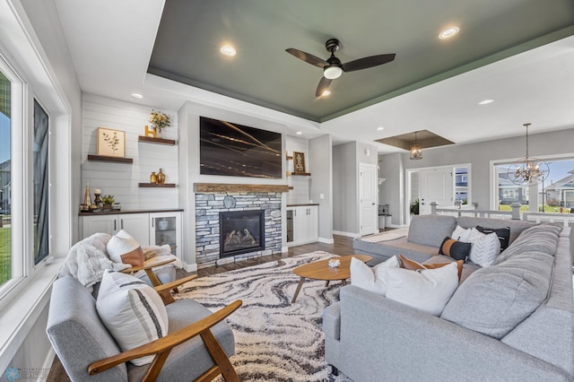 1991 69th Ave S, Fargo, ND 58104 - living room featuring ceiling fan, recessed lighting, wood finished floors, a fireplace, and a tray ceiling