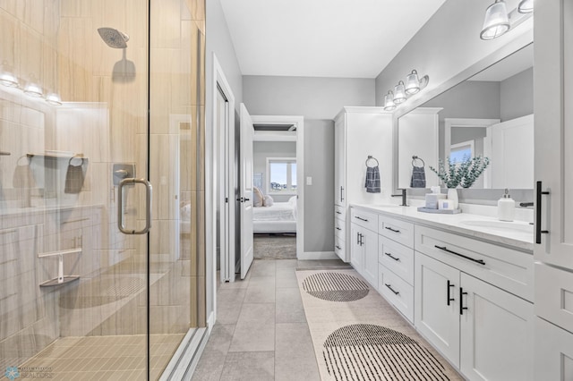 1991 69th Ave S, Fargo, ND 58104 - ensuite bathroom featuring double vanity, a shower stall, baseboards, and tile patterned floors
