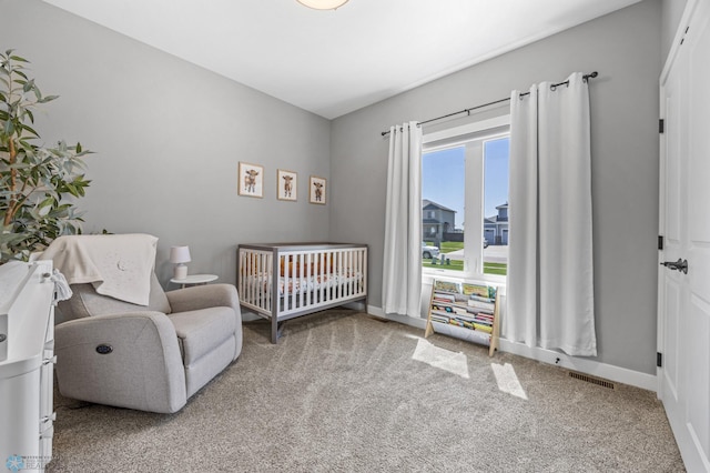 1991 69th Ave S, Fargo, ND 58104 - carpeted bedroom with a crib and baseboards