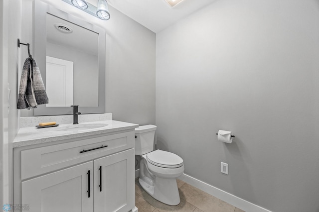 1991 69th Ave S, Fargo, ND 58104 - half bathroom featuring toilet, vanity, baseboards, and tile patterned floors