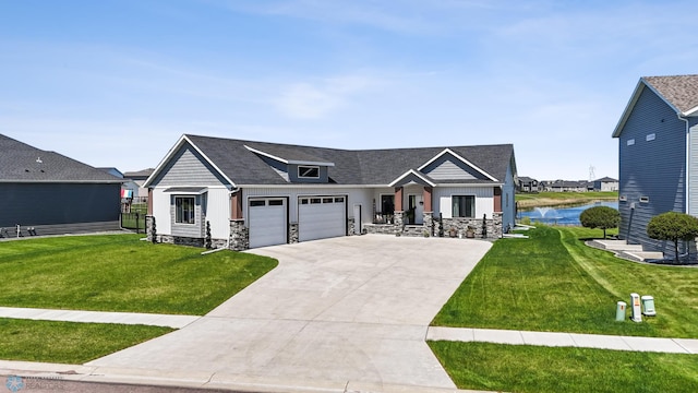 1991 69th Ave S, Fargo, ND 58104 - view of front of house with an attached garage, a water view, a front yard, and concrete driveway