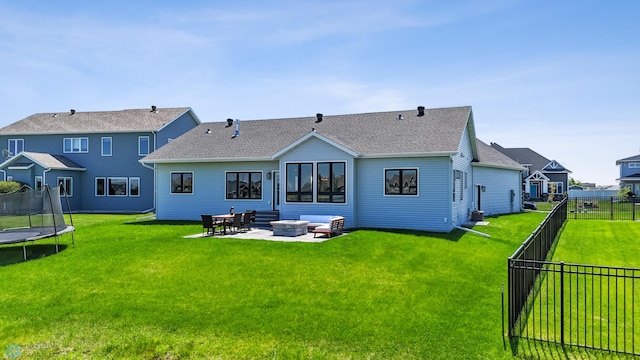 1991 69th Ave S, Fargo, ND 58104 - back of house with a trampoline, a patio area, an outdoor fire pit, and a shingled roof