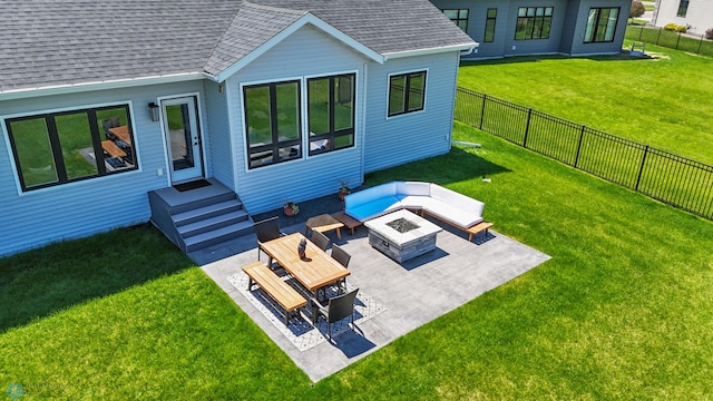 1991 69th Ave S, Fargo, ND 58104 - rear view of property featuring a shingled roof, a patio, and an outdoor living space with a fire pit