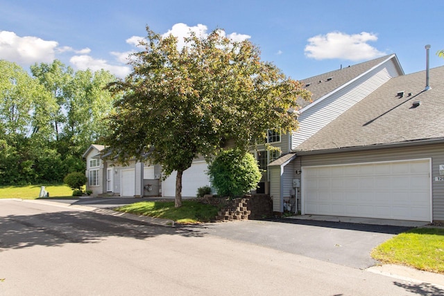 12977 Echo Ln, Apple Valley, MN 55124 - view of front of home featuring driveway, roof with shingles, and a garage