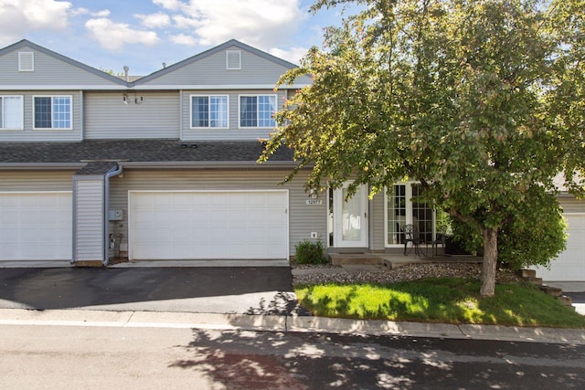 12977 Echo Ln, Apple Valley, MN 55124 - view of front of home featuring driveway, an attached garage, and roof with shingles
