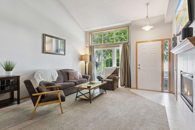 12977 Echo Ln, Apple Valley, MN 55124 - living area featuring high vaulted ceiling, light tile patterned floors, a tiled fireplace, and baseboards